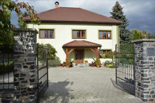 a house with a gate in front of it at Penzion U Horských in Čáslav