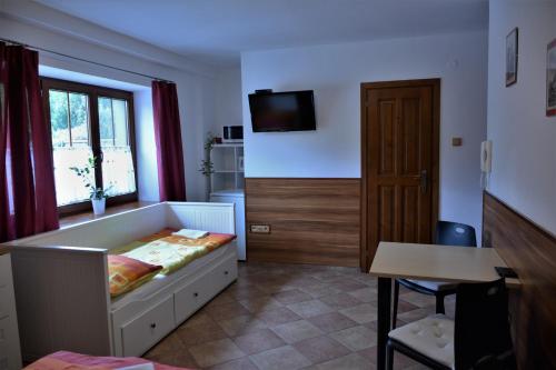 een slaapkamer met een bed, een tafel en een raam bij Penzion U Horských in Čáslav
