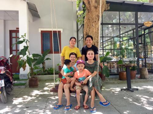 a group of people sitting on a swing at Eden House & Coffee Con Dao in Con Dao