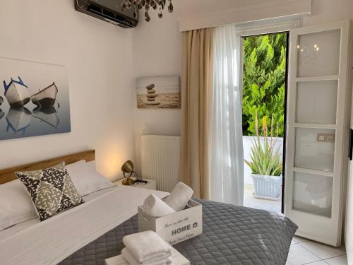 a bedroom with a bed with a large window at PORTA HOME modern and hospitable in Naxos Chora