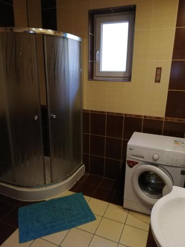 a bathroom with a washing machine and a window at Halex 3 in Bojná