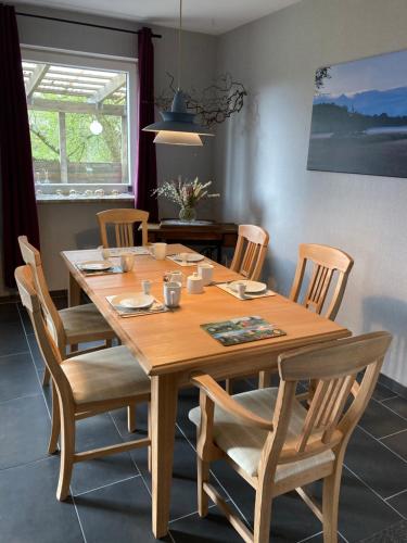 a wooden table with chairs and a dining room at Haus Wald und Wiese Wohnung Wald in Ehndorf
