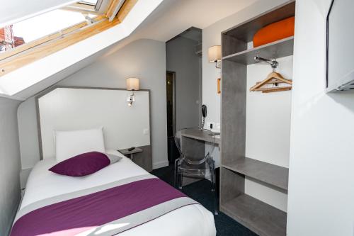 a small bedroom with a bed and a sink at Hôtel de Champagne in Angers