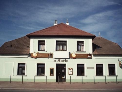 a large white building with a brown roof at Hotel U Karla in Prague
