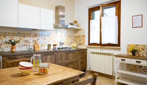a kitchen with a wooden table in a kitchen at Agriturismo Salcino in Grosseto