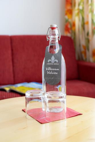 a bottle of water sitting on a table at Hotel Latini in Zell am See