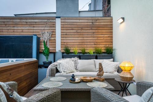 a patio with a couch and a table at Sting Old Town Ostrava in Ostrava