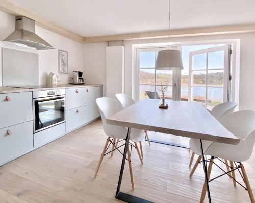 a kitchen and dining room with a table and chairs at See 11 in Harrislee