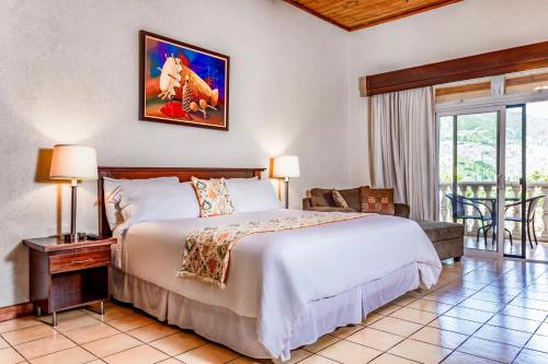 a bedroom with a large bed and a balcony at Hotel Villa Therese in Port-au-Prince