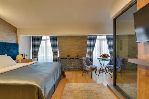 A bed or beds in a room at Grande Stella Hotel