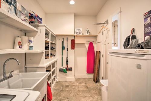 a kitchen with white cabinets and a sink at Lovely Canyon View Apartment with Patio and Yard in Silverton