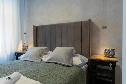 a bedroom with a bed with a wooden headboard at Sting Old Town Ostrava in Ostrava