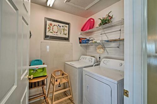 a laundry room with two washing machines and a shelf at Murrells Inlet Home with 3 Decks - 1 Block to Beach! in Myrtle Beach