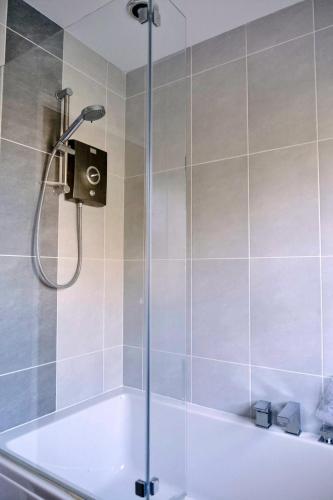 a shower in a bathroom with a bath tub at Finest Retreats - Charnwood in Lewannick