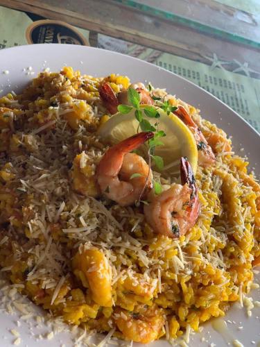 a plate of food with shrimp and rice at Pousada Convés - Ilha Grande in Praia de Araçatiba
