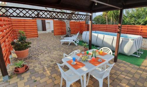 d'une terrasse avec une table et une baignoire. dans l'établissement CASA BALICE, à Monopoli