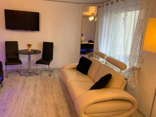 a living room with a couch and a table at Hotel Am Müritzhafen garni in Waren