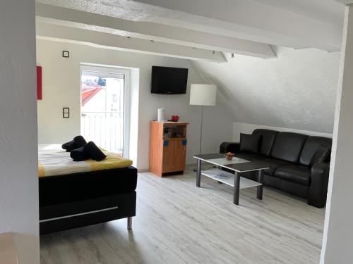 a living room with a couch and a table at Hotel Am Müritzhafen garni in Waren