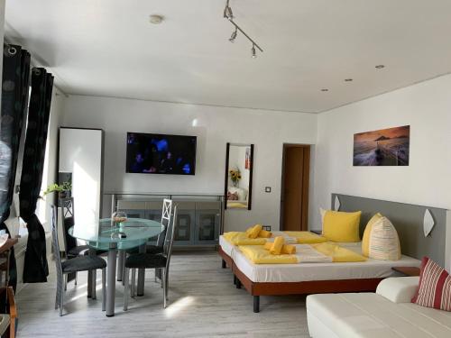 a living room with a couch and a table at Hotel Am Müritzhafen garni in Waren