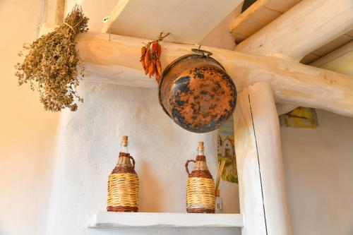 two bottles of beer on a shelf in a room at Belgodere di Mezzavia Apartments in Ischia