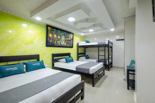 two beds in a room with two bunk beds at Ayenda Castillo Real 1521 in Bucaramanga