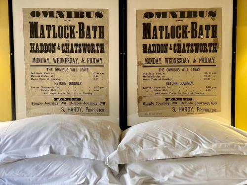 two white pillows sitting on top of a bed at Priesthill HotTub Pool Dog Friendly PeakDistrict in Stanton in Peak