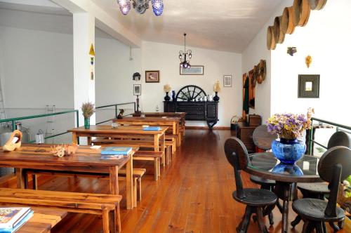 a dining room with wooden tables and chairs at Quinta Das Escomoeiras in Celorico de Basto