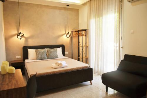 a bedroom with a bed with two towels on it at Studios Periklis in Limenas