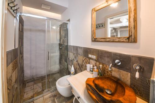 a bathroom with a sink and a shower at Belgodere di Mezzavia Apartments in Ischia
