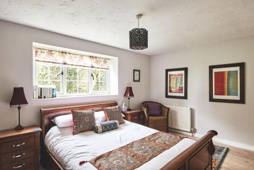 a bedroom with a bed and a window at Harcombe Cottage in Stockland
