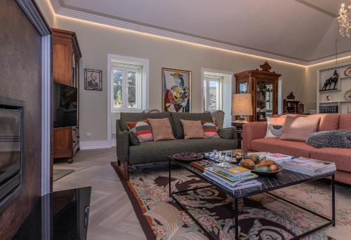 a living room with a couch and a table at Casa das Margaridas in Vale de Lobo