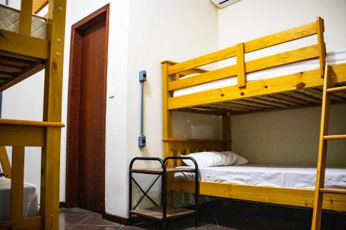 a room with two bunk beds and a hallway at Esquina 8 Suítes Confort & Hostel in Florianópolis