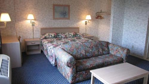 a hotel room with a bed and a couch at Nisei Inn in Gardena