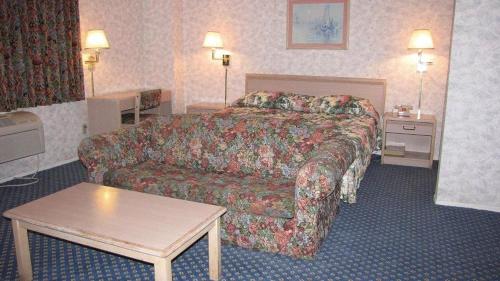 a hotel room with a bed and a couch at Nisei Inn in Gardena