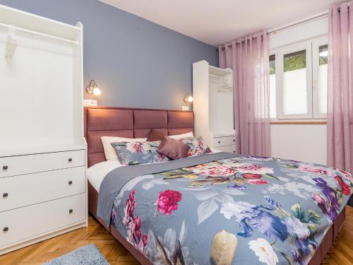 Schlafzimmer mit einem Bett, einer Kommode und Fenstern in der Unterkunft Porec TWINS Apartment in Poreč
