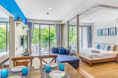 a bedroom with a bed and a couch at Baan San Kraam Cha Am-Hua Hin by Favstay in Cha Am