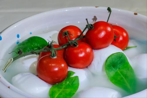 a group of tomatoes in a bowl of milk at Borgo Pallavicini Mori in Prima Porta