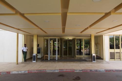 a man standing in front of a building at Hala Hotel & Aqua Park in Bissau