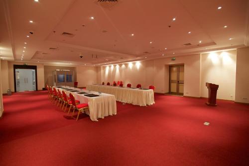 a large room with tables and chairs in it at Hala Hotel & Aqua Park in Bissau