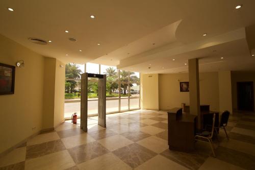 a lobby with a table and chairs in a building at Hala Hotel & Aqua Park in Bissau
