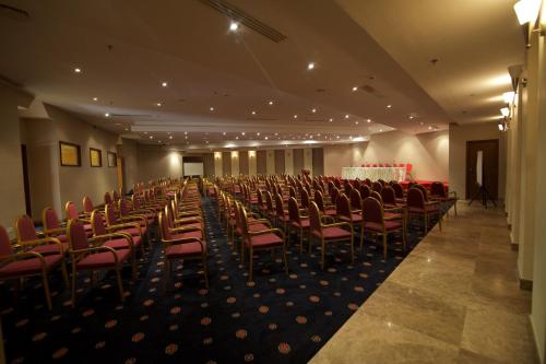 a large room with chairs and a table in it at Hala Hotel & Aqua Park in Bissau