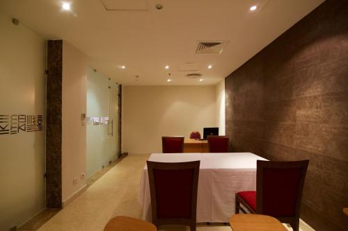 a dining room with a table and chairs at Hala Hotel & Aqua Park in Bissau