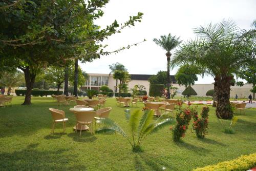 a group of tables and chairs in a park at Hala Hotel & Aqua Park in Bissau
