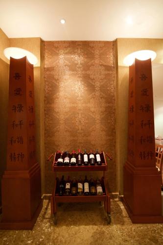 a shelf with bottles of wine in a room at Hala Hotel & Aqua Park in Bissau
