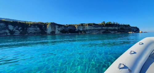 a view of the ocean from a boat in the water at Borgo di Santa Barbara in Santa Domenica