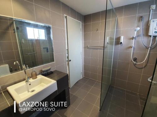 a bathroom with a sink and a shower at Aeropod Sovo Kota Kinabalu By LAXZONE in Kota Kinabalu