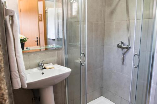 a bathroom with a shower with a sink and a toilet at Partezins III in Castelo de Paiva