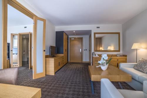 a living room with a couch and a table at Grand Nosalowy Dwór in Zakopane