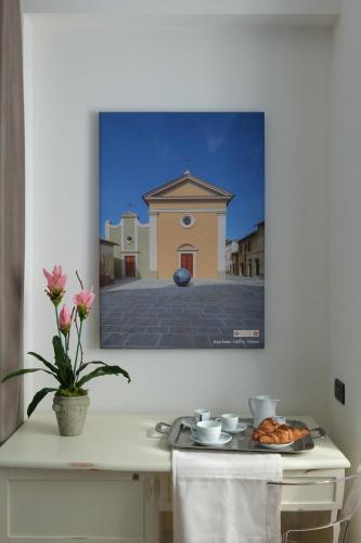 a picture of a building on a wall at Hotel Portavaldera in Peccioli