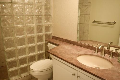 a bathroom with a sink and a toilet and a mirror at Beautiful Private Condo Walking Distance to Beach MV2321 in Kihei